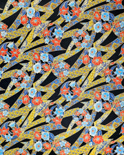 Japanese chiyogami paper featuring red & blue flowers and yellow ribbons with a shippo and floral pattern on a black background with metallic gold accents.