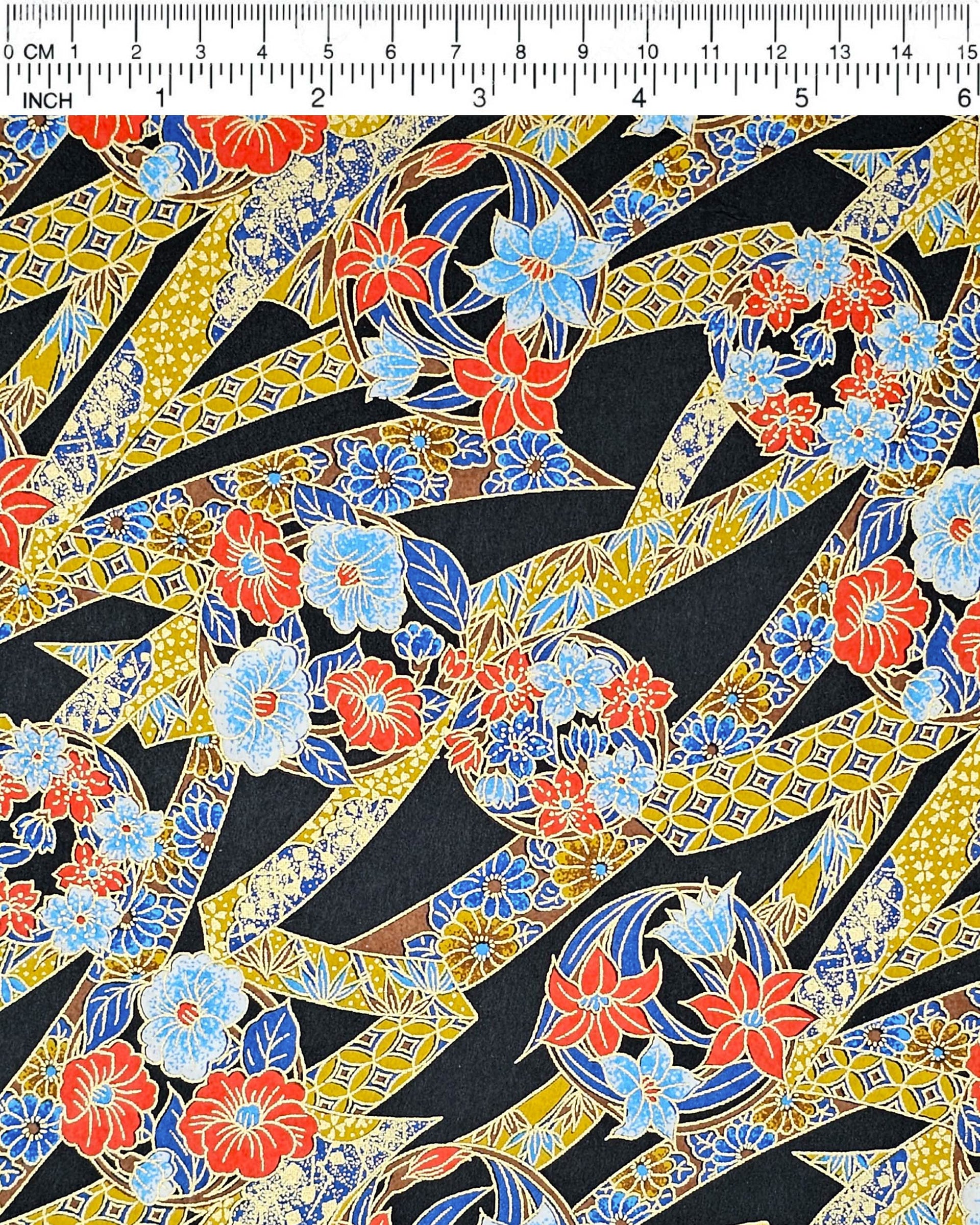 Japanese chiyogami paper featuring red & blue flowers and yellow ribbons with a shippo and floral pattern on a black background with metallic gold accents.