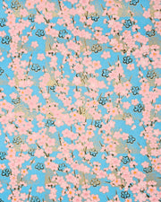 Japanese chiyogami featuring pink plum blossoms and black plum blossom outines on a light blue background with metallic gold accents.