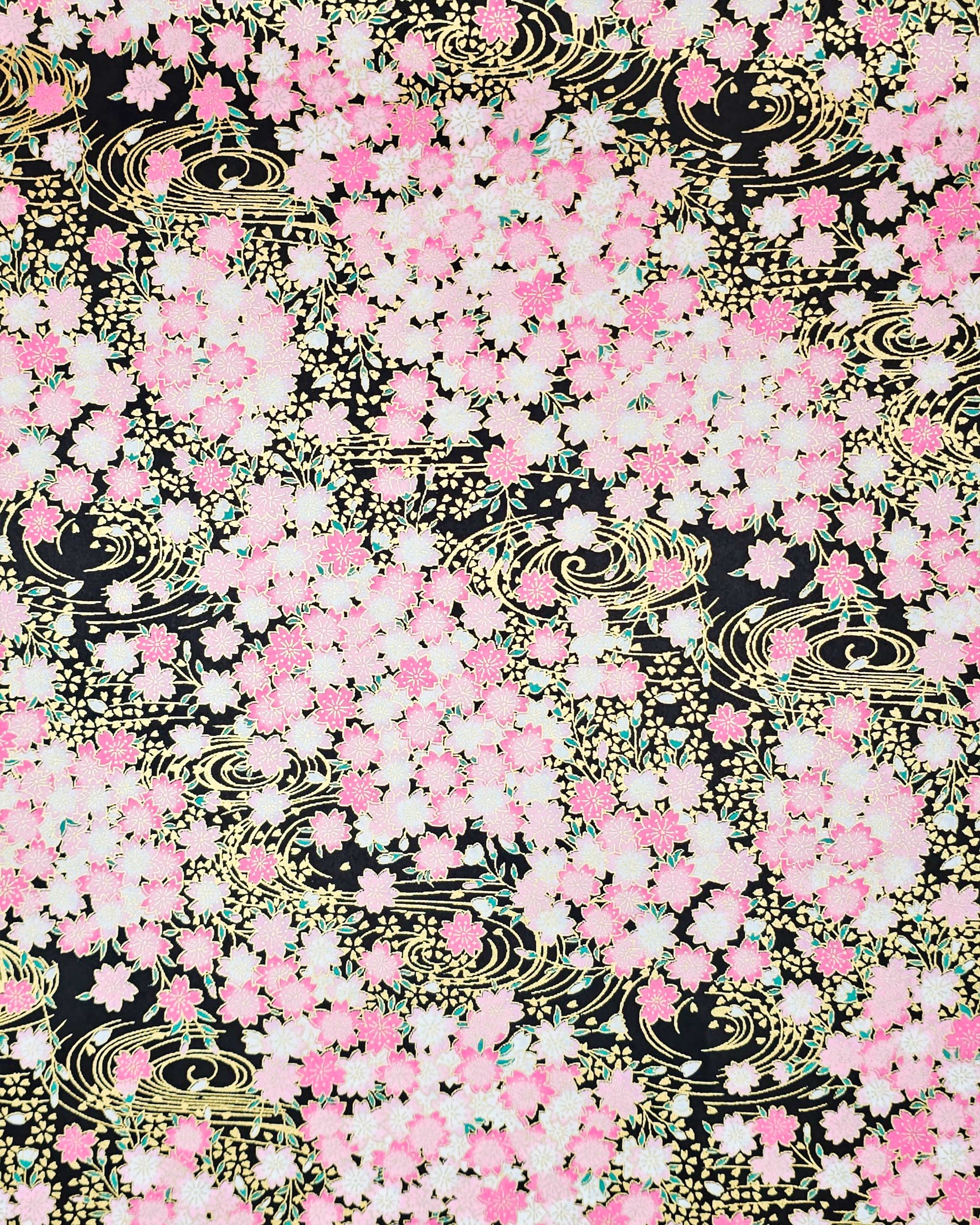 Japanese chiyogami featuring pink cherry blossoms on a black background with metallic gold accents.