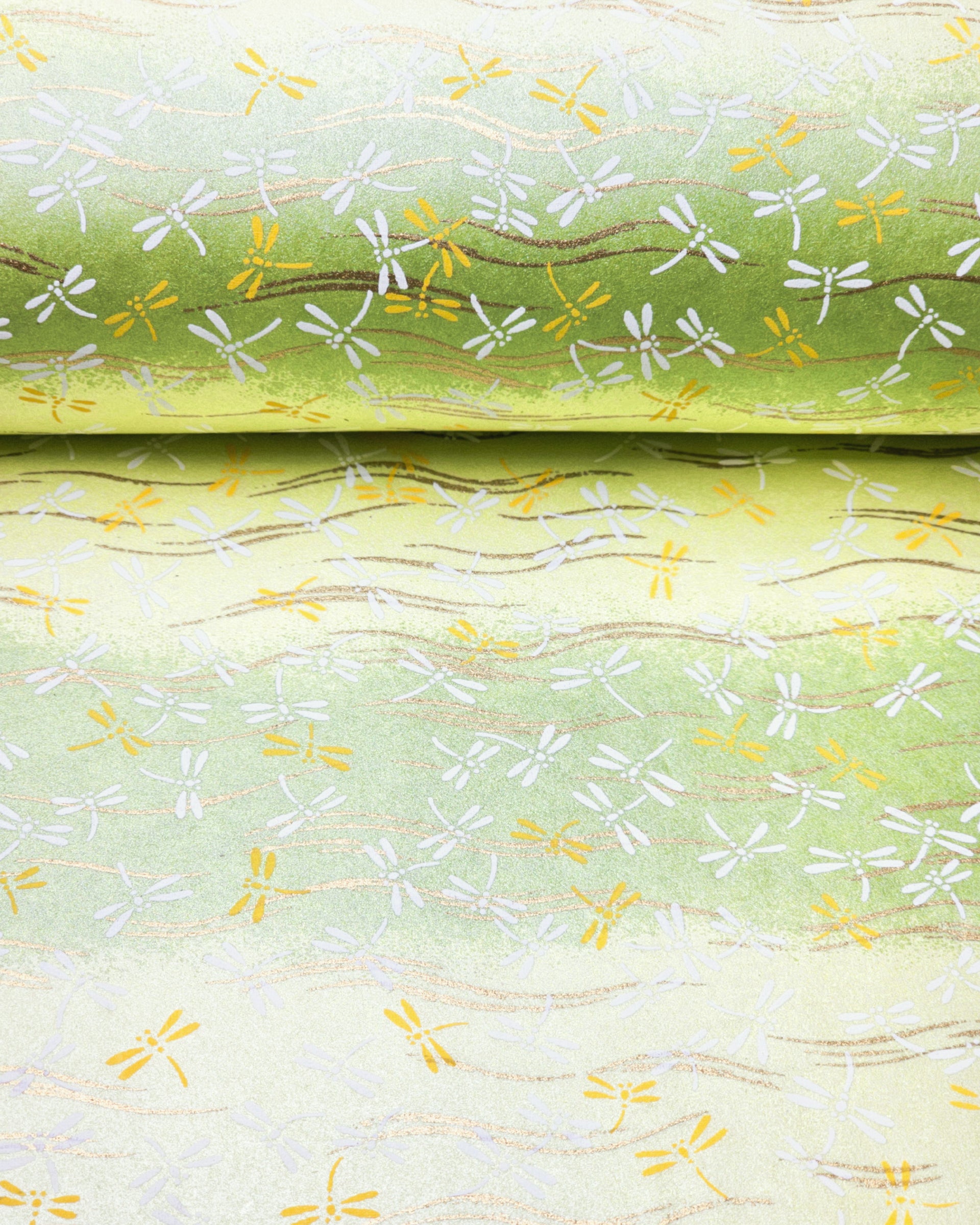 Japanese chiyogami paper featuring yellow and white dragonflies on a pearlescent green background with metallic gold accents.