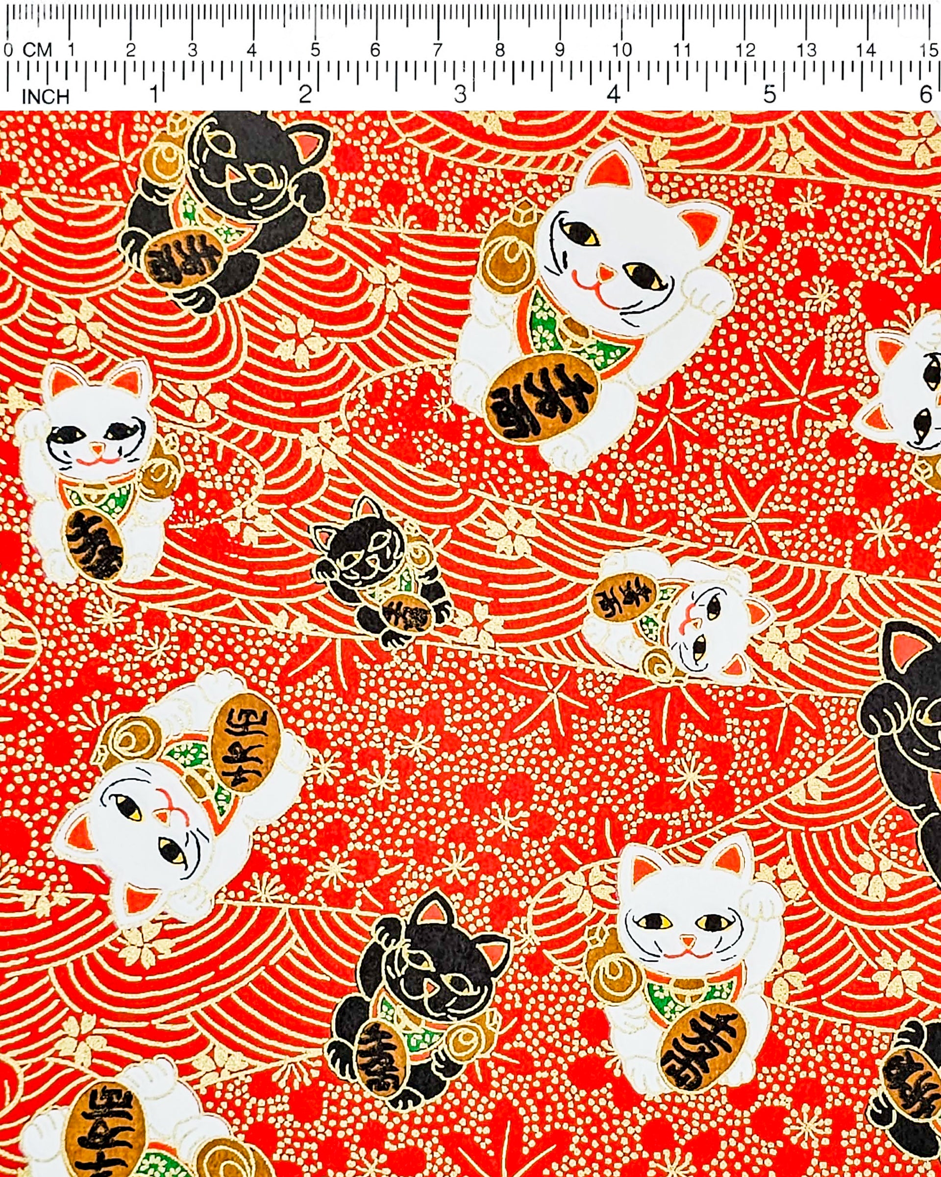 Japanese chiyogami paper featuring black & white lucky cats on a red background with metallic gold accents.