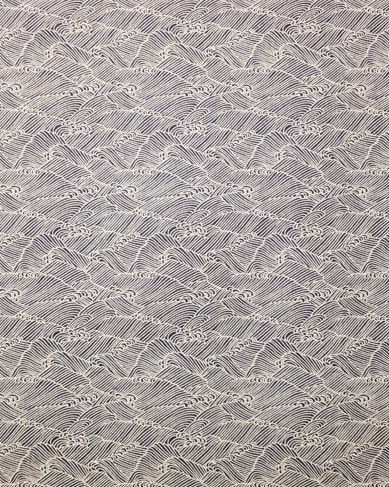 Japanese chiyogami featuring small metallic gold waves on a black background.