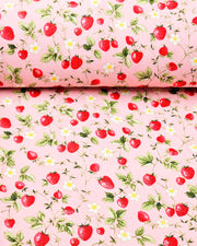 Japanese chiyogami paper featuring red strawberries with green leaves and white flowers on a pink background.