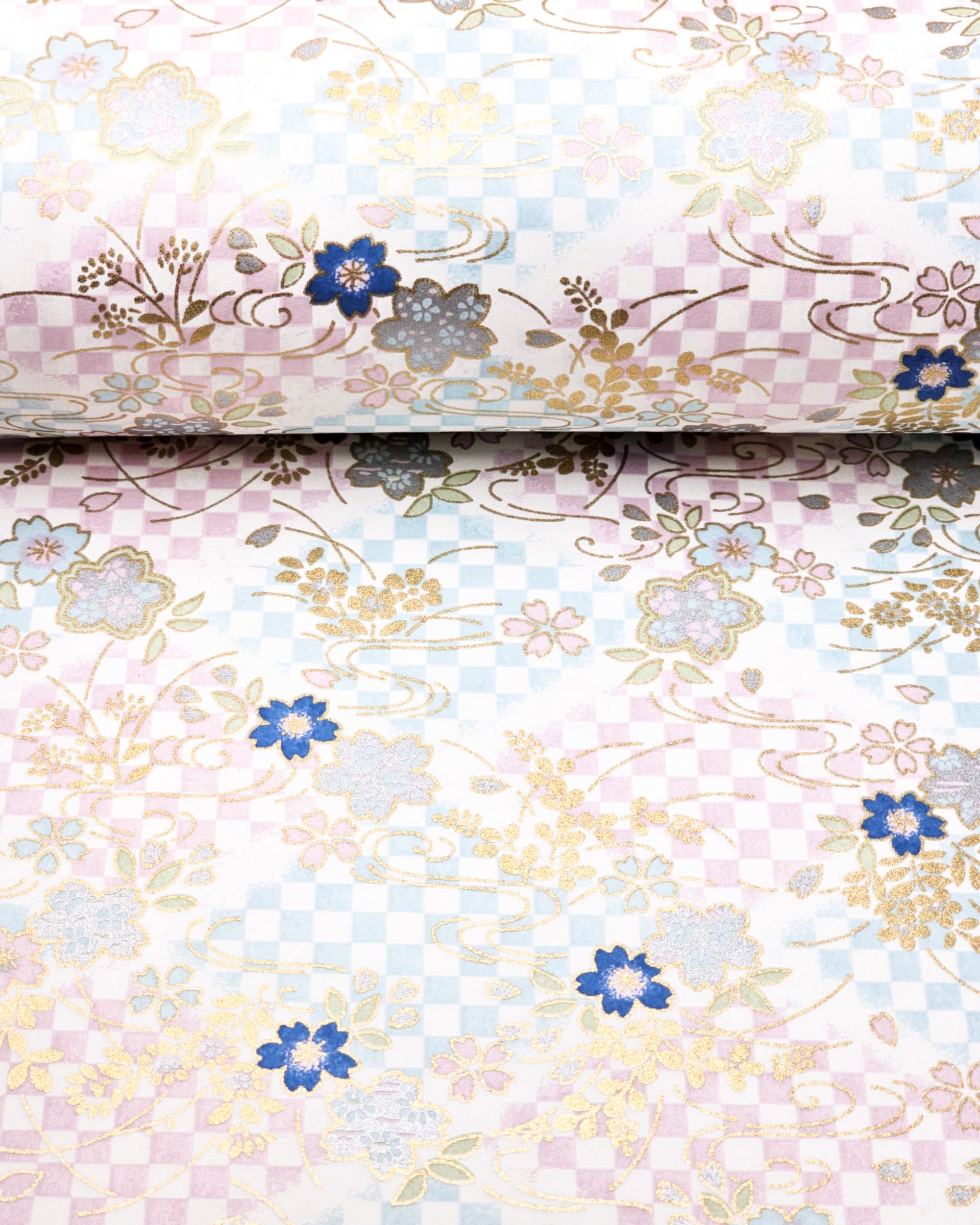 Japanese chiyogami paper featuring blue & pink cherry blossoms on a blue & purple ichimatsu (checkered) background with metallic gold & silver accents.
