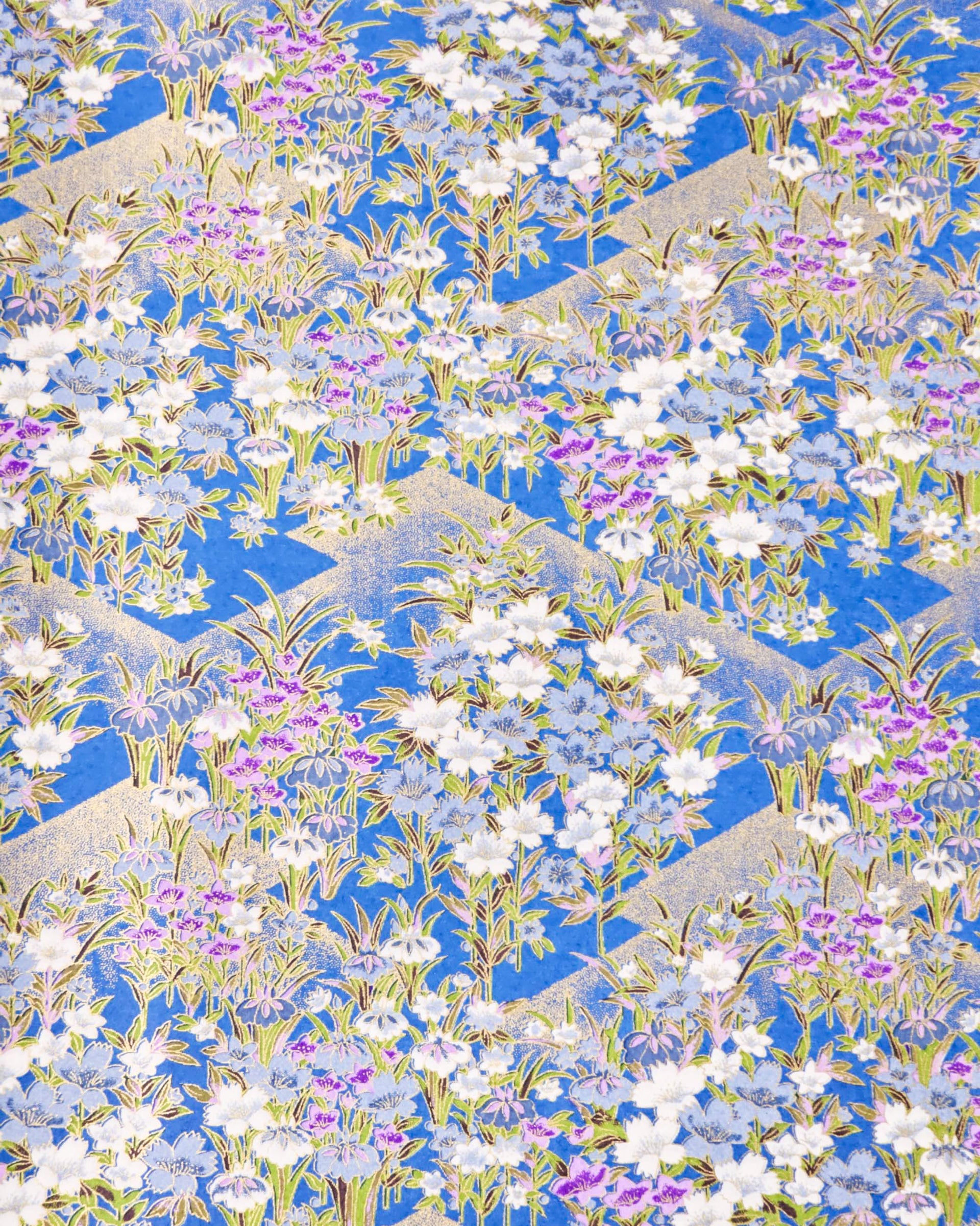 Japanese chiyogami paper featuring blue, purple, and white irises on a royal blue background with metallic gold accents.