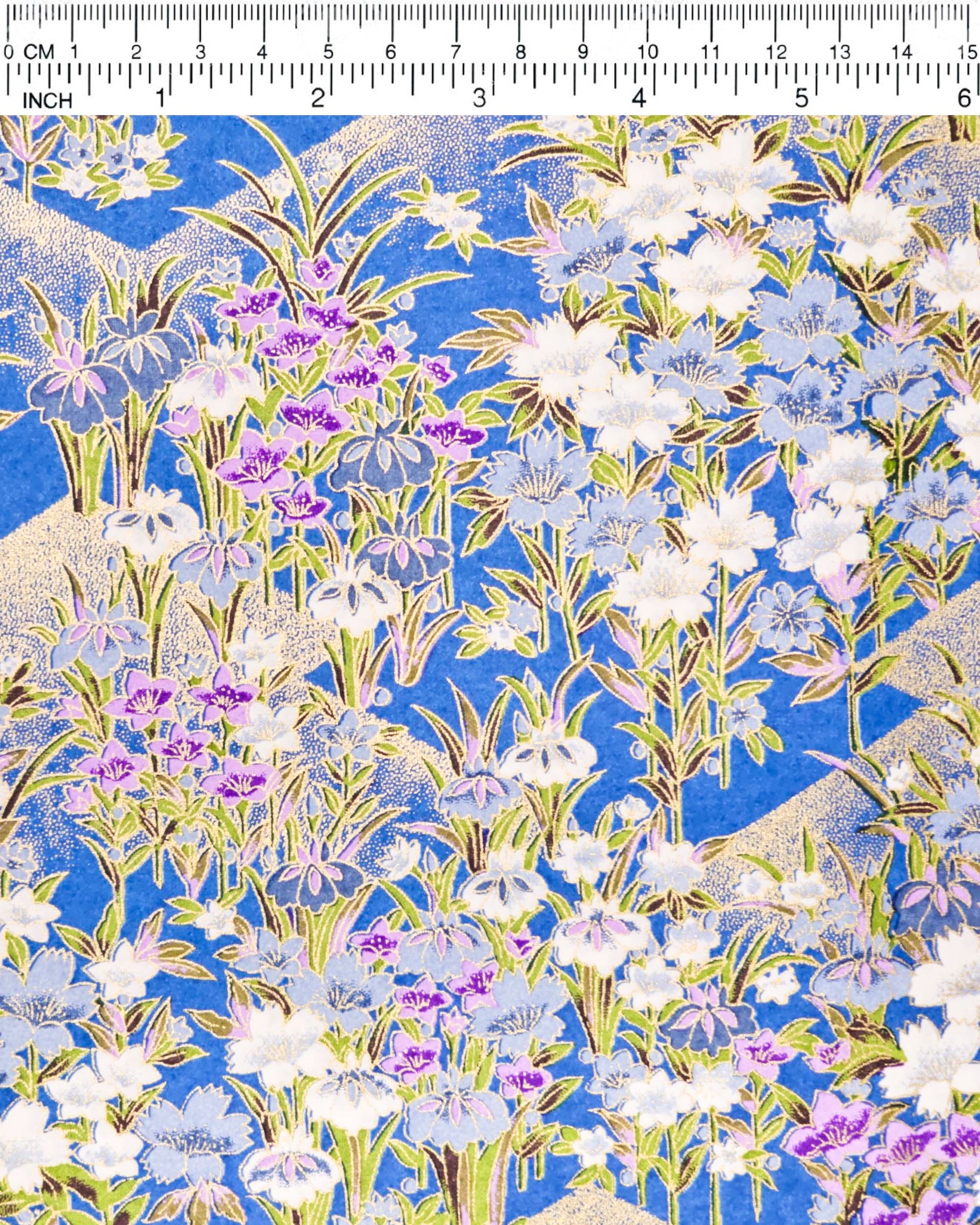 Japanese chiyogami paper featuring blue, purple, and white irises on a royal blue background with metallic gold accents.