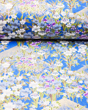 Japanese chiyogami paper featuring blue, purple, and white irises on a royal blue background with metallic gold accents.