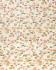Japanese chiyogami featuring white origami cranes with green plants and red plum blossoms on a metallic gold background.