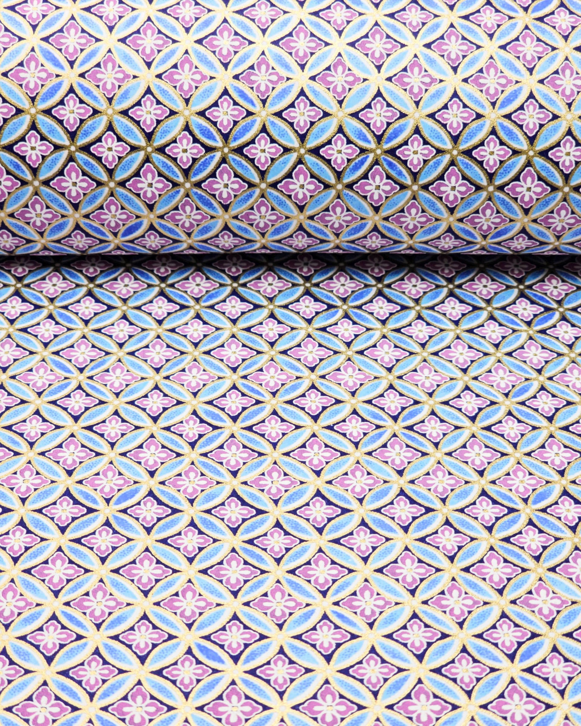 Japanese chiyogami paper featuring a blue shippo design with purple hanabishi in the center with metallic gold accents.