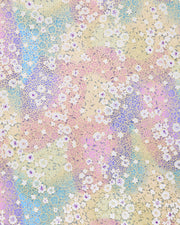 Japanese chiyogami paper featuring small rainbow-colored flowers with metallic gold accents.