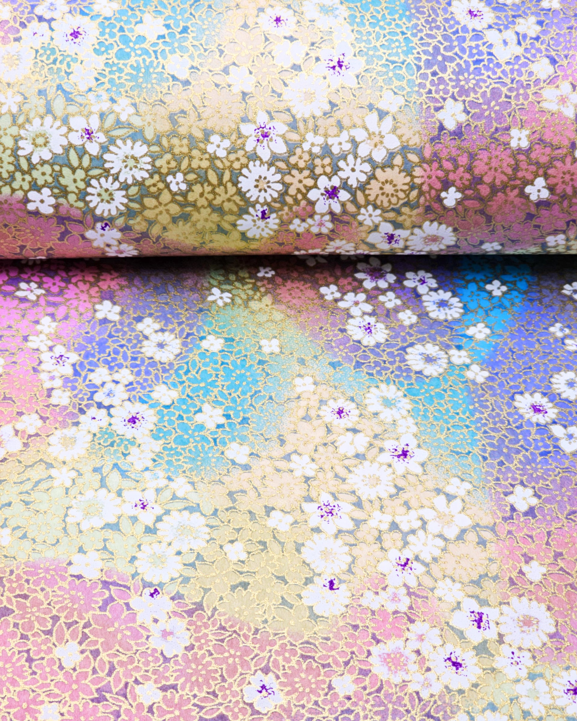 Japanese chiyogami paper featuring small rainbow-colored flowers with metallic gold accents.