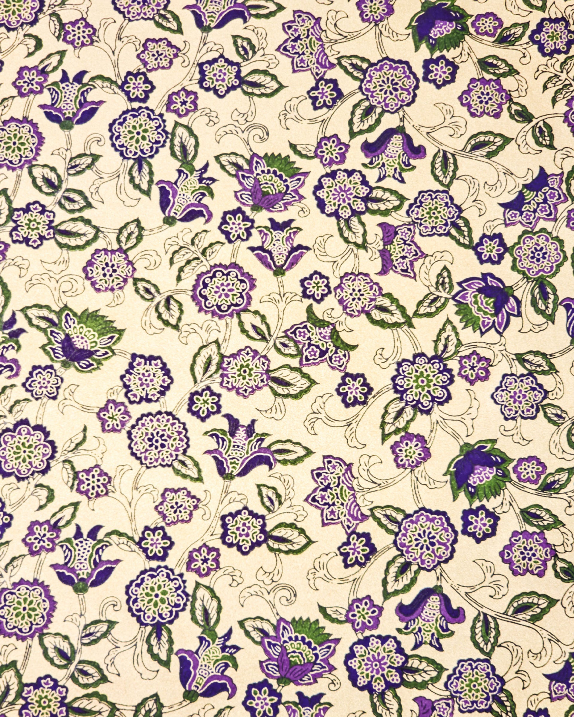 Japanese chiyogami paper featuring purple & green sarasa flowers on a metallic gold background.