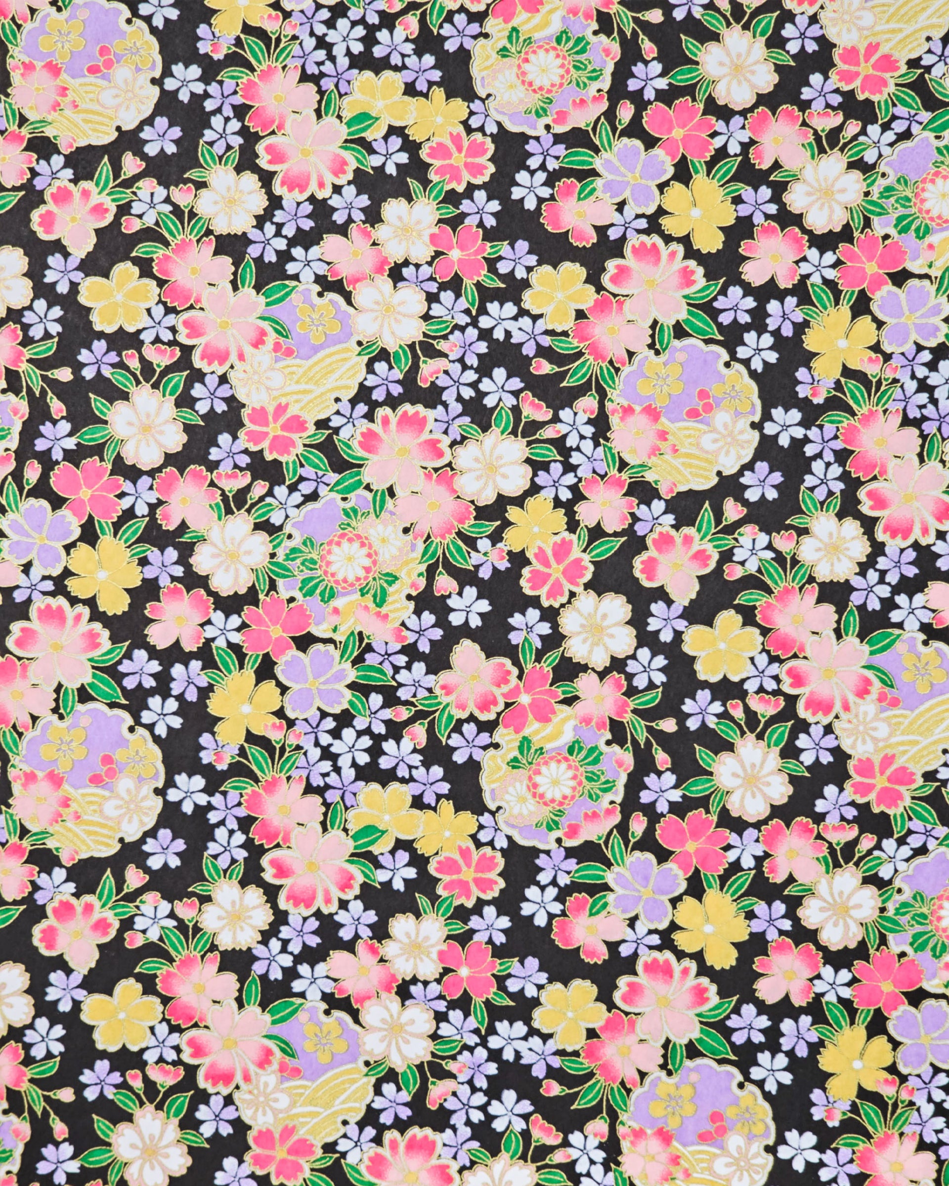 Japanese chiyogami paper featuring pink, yellow, purple, and white cherry blossoms and purple yukiwas on a black background with metallic gold accents.