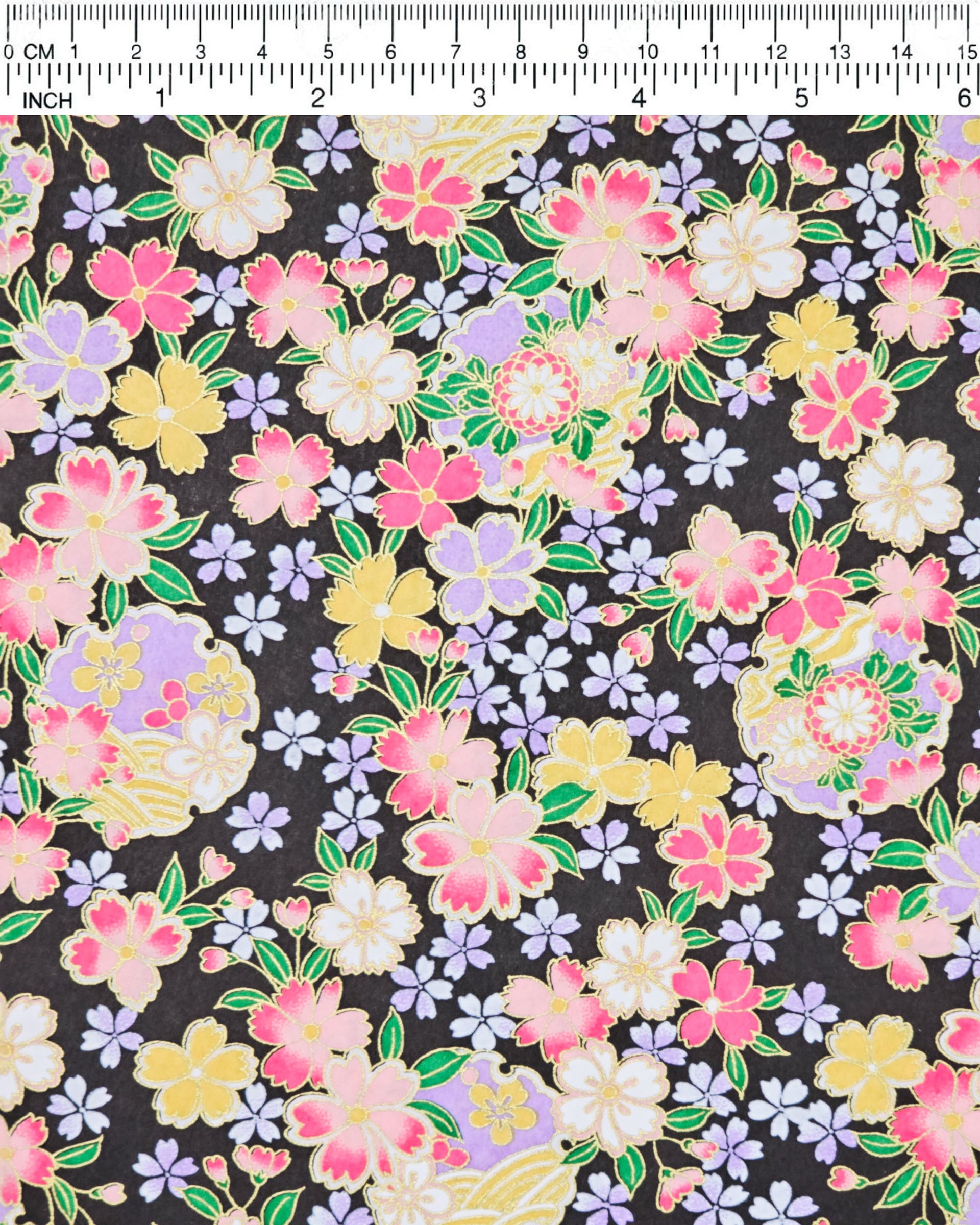 Japanese chiyogami paper featuring pink, yellow, purple, and white cherry blossoms and purple yukiwas on a black background with metallic gold accents.