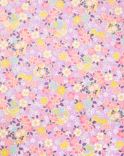 Japanese chiyogami paper featuring pink, yellow, blue, and white cherry blossoms and purple yukiwas on a purple background with metallic gold accents.