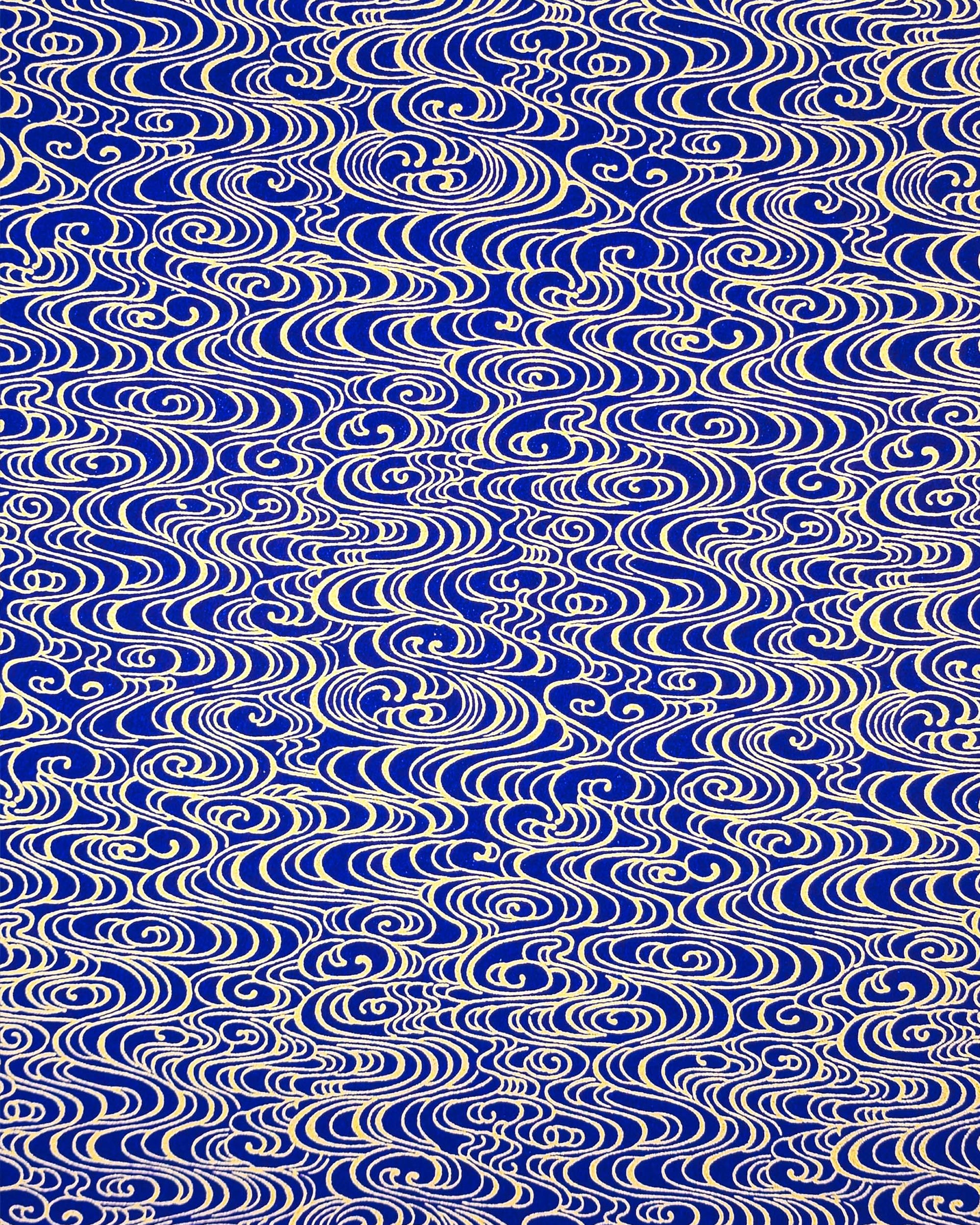 Japanese chiyogami paper featuring metallic gold water ripples on a dark blue background