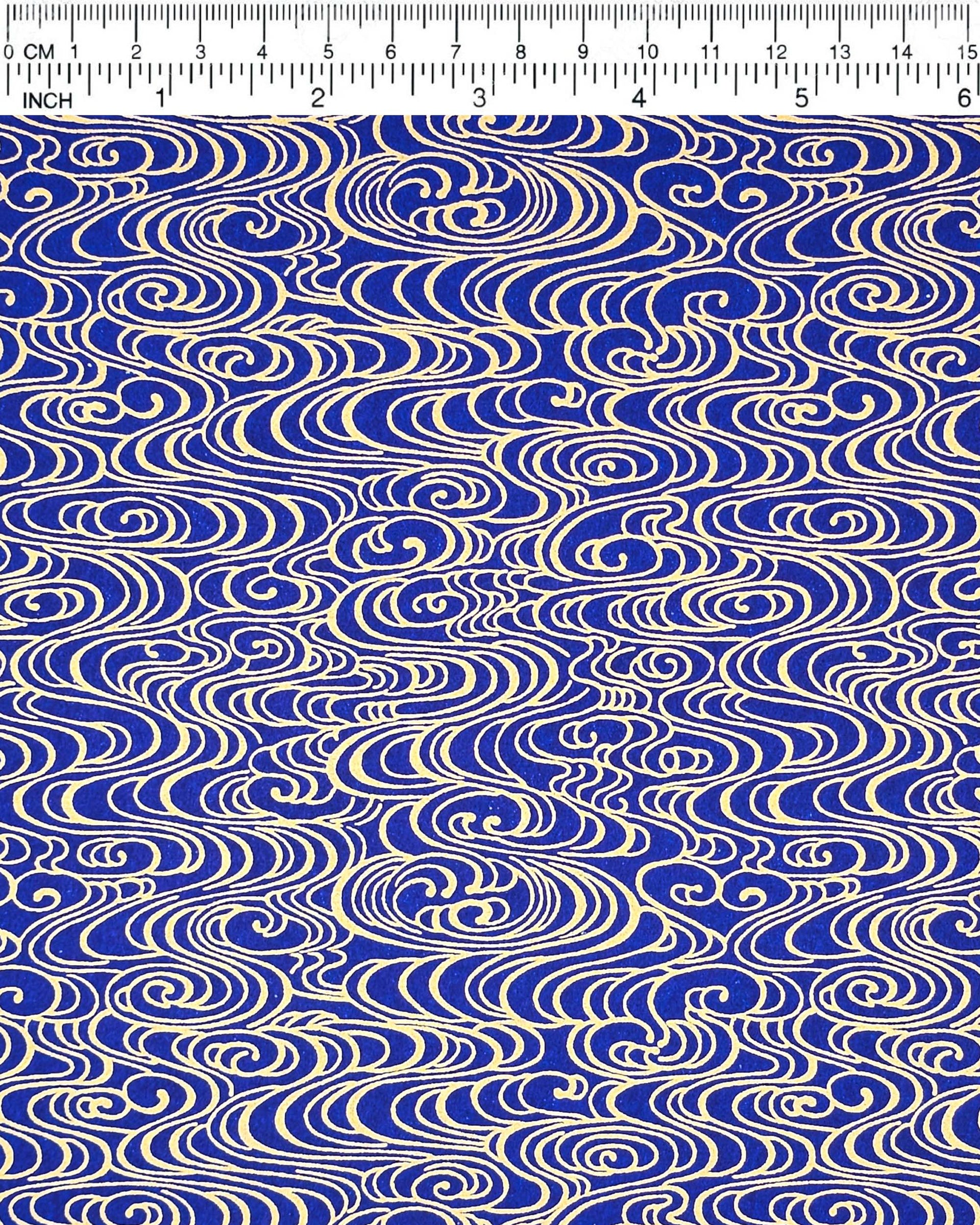 Japanese chiyogami paper featuring metallic gold water ripples on a dark blue background