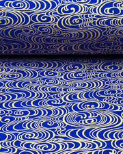 Japanese chiyogami paper featuring metallic gold water ripples on a dark blue background