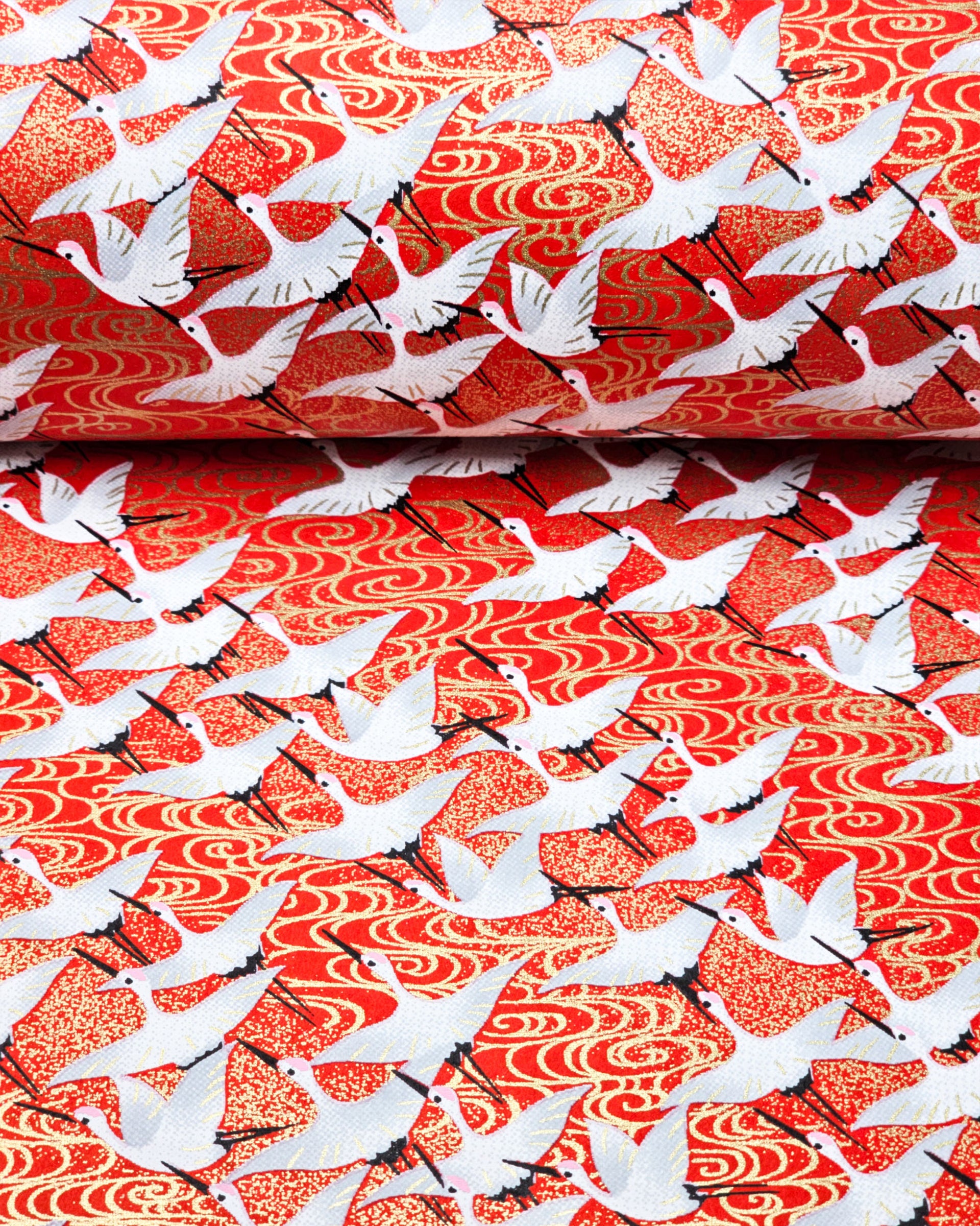 Japanese chiyogami paper featuring white flying cranes on an red background with metallic gold accents.
