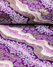 Japanese chiyogami paper featuring pink & white cherry blossoms on purple background with metallic gold & silver accents.