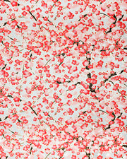 Japanese chiyogami paper featuring a red plum blossom tree with a dark brown tree trunk on a metallic silver background with metallic gold accents.