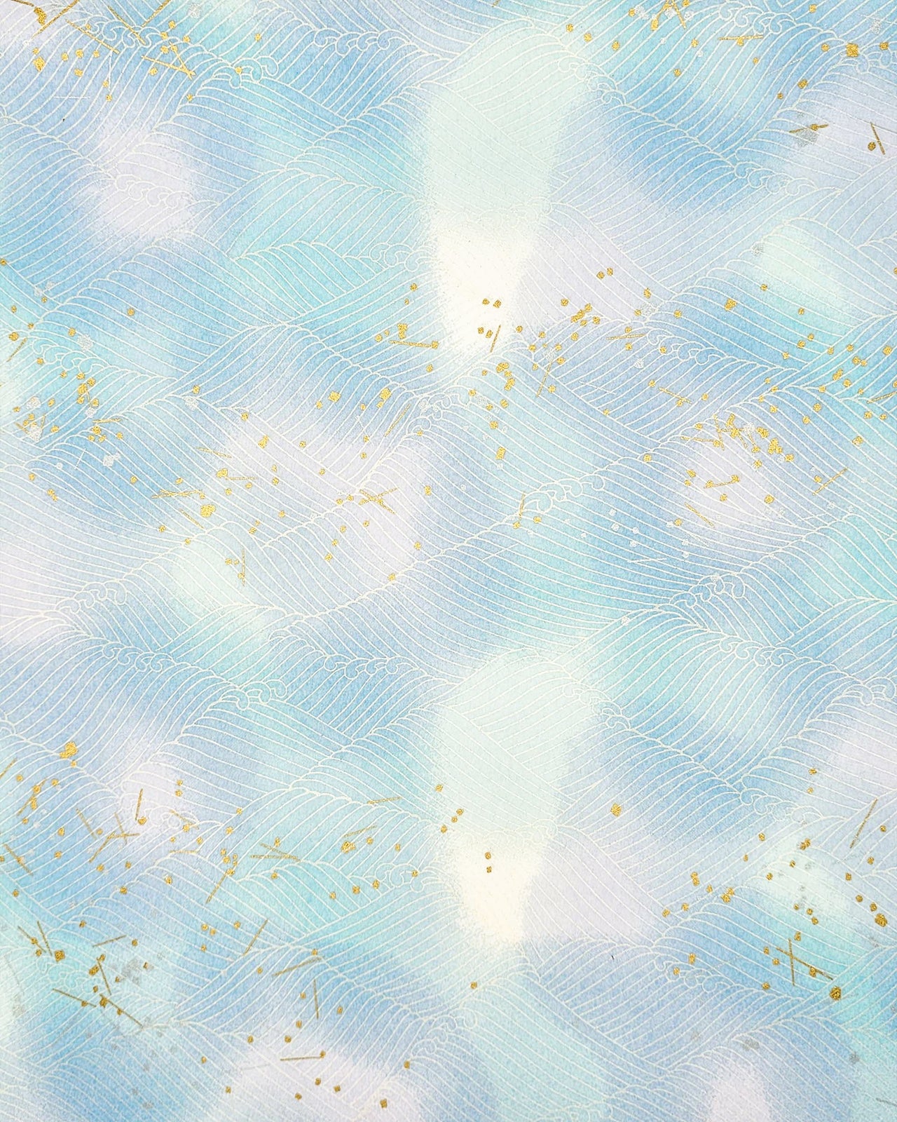 Japanese chiyogami paper featuring white waves on a blue & purple background with metallic gold and silver accents.