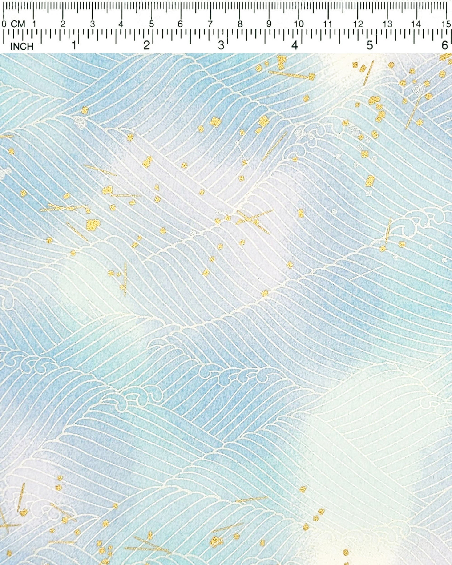 Japanese chiyogami paper featuring white waves on a blue & purple background with metallic gold and silver accents.
