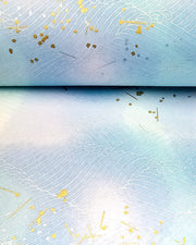 Japanese chiyogami paper featuring white waves on a blue & purple background with metallic gold and silver accents.