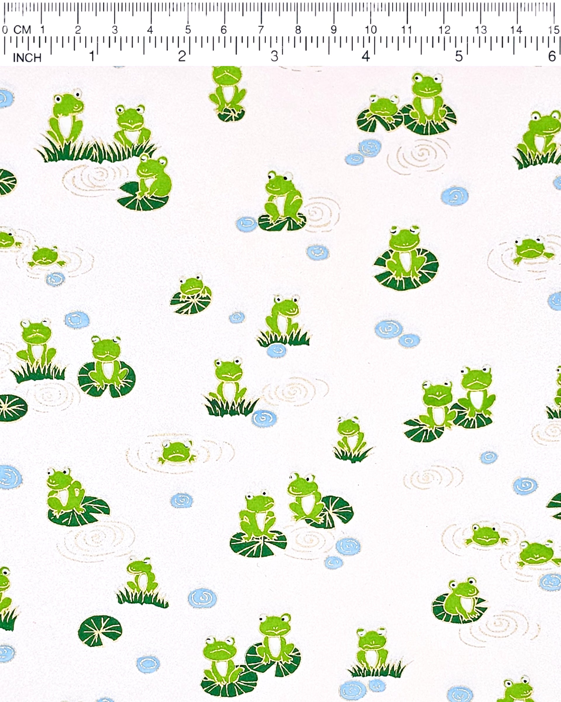 Japanese chiyogami featuring green frogs sitting on green lily pads on a pearlescent pink background with metallic gold accents.