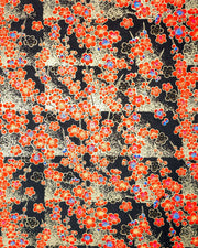 Japanese chiyogami featuring red plum blossoms with a little bit of blue on a black background with metallic gold accents.