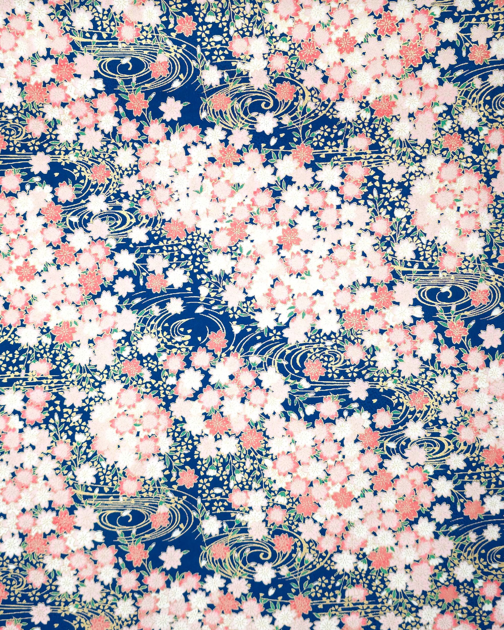 Japanese chiyogami featuring pink cherry blossoms on a blue background with metallic gold accents.