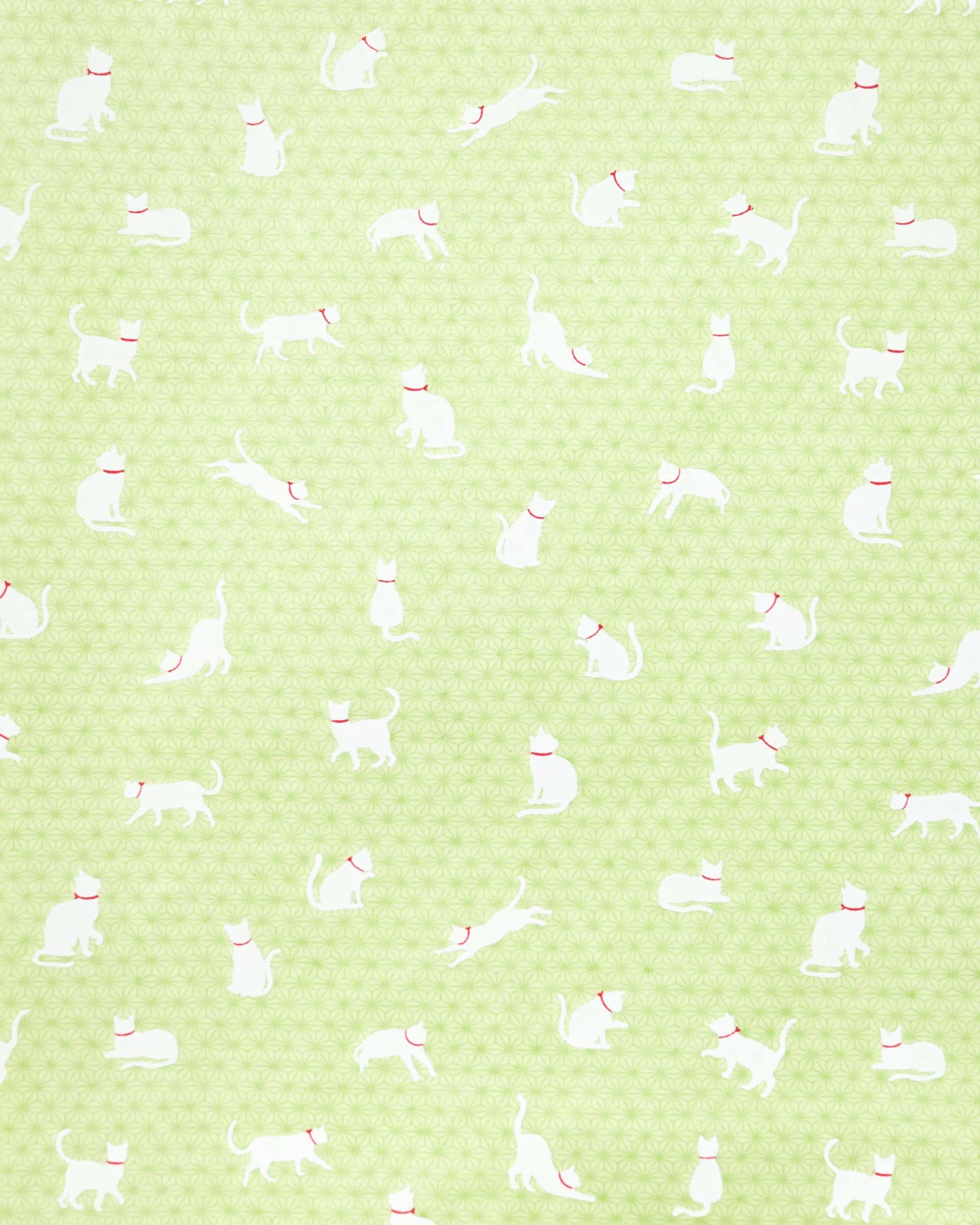 Japanese chiyogami featuring white cats with red collars on a green asanoha (hemp leaf) background.