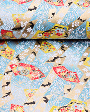 Japanese chiyogami paper featuring yellow & red hand fans on a blue background with metallic gold accents.