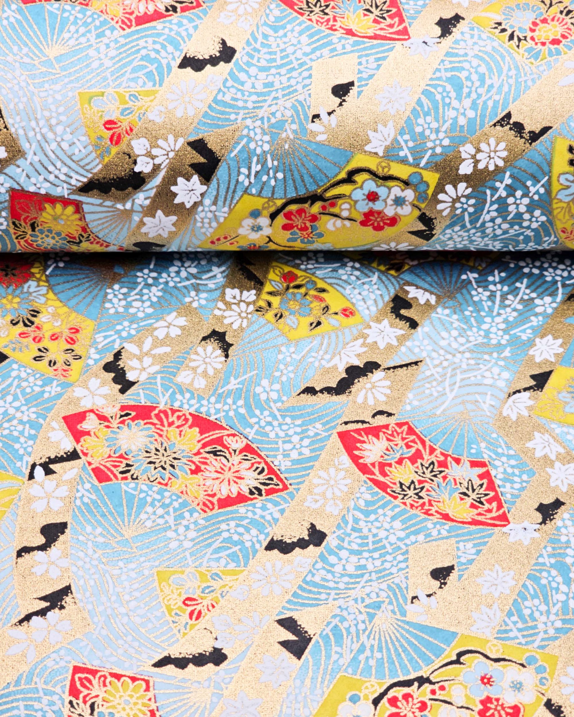 Japanese chiyogami paper featuring yellow & red hand fans on a blue background with metallic gold accents.