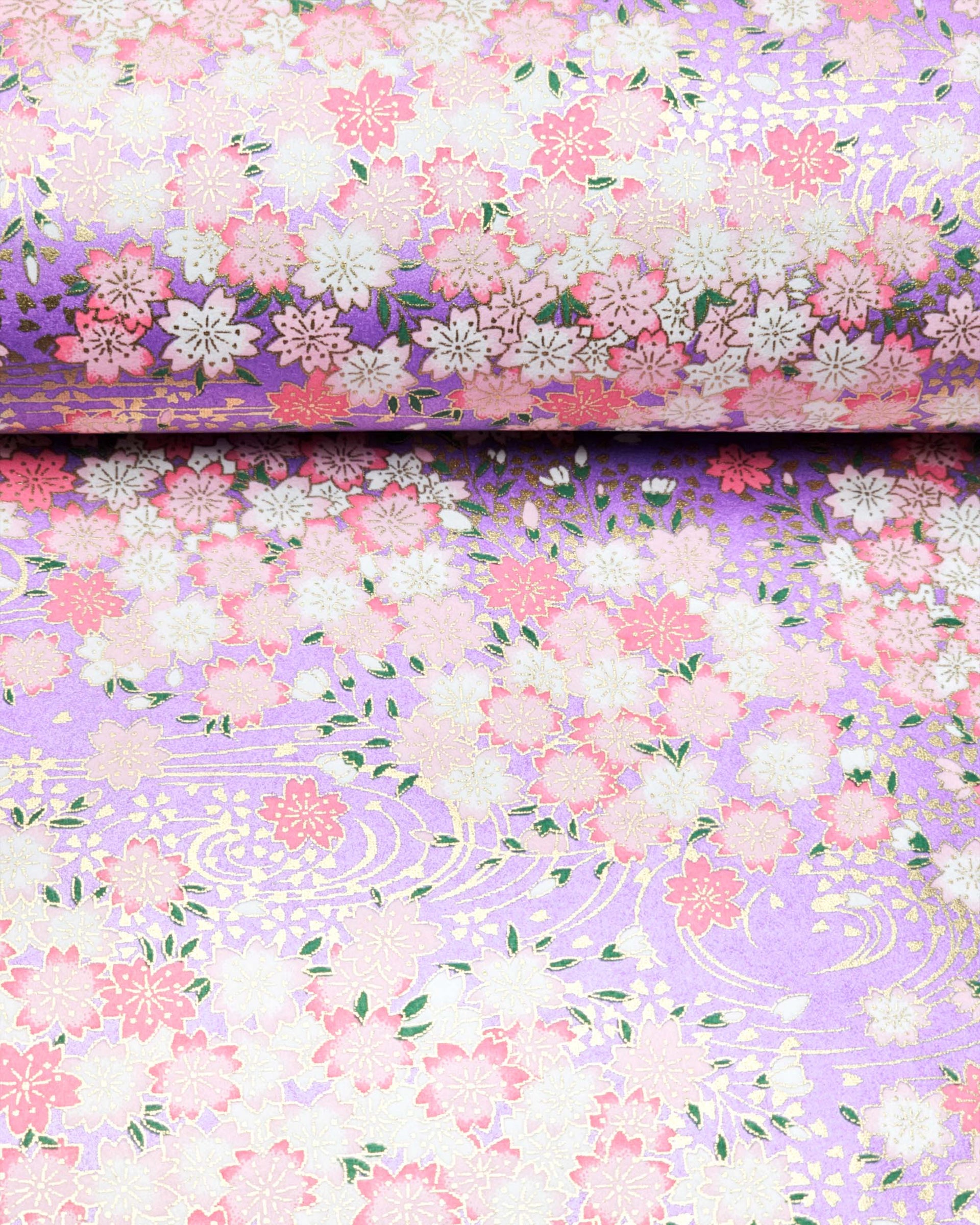 Japanese chiyogami paper featuring pink & white cherry blossoms on a pearlescent purple background with metallic gold accents.