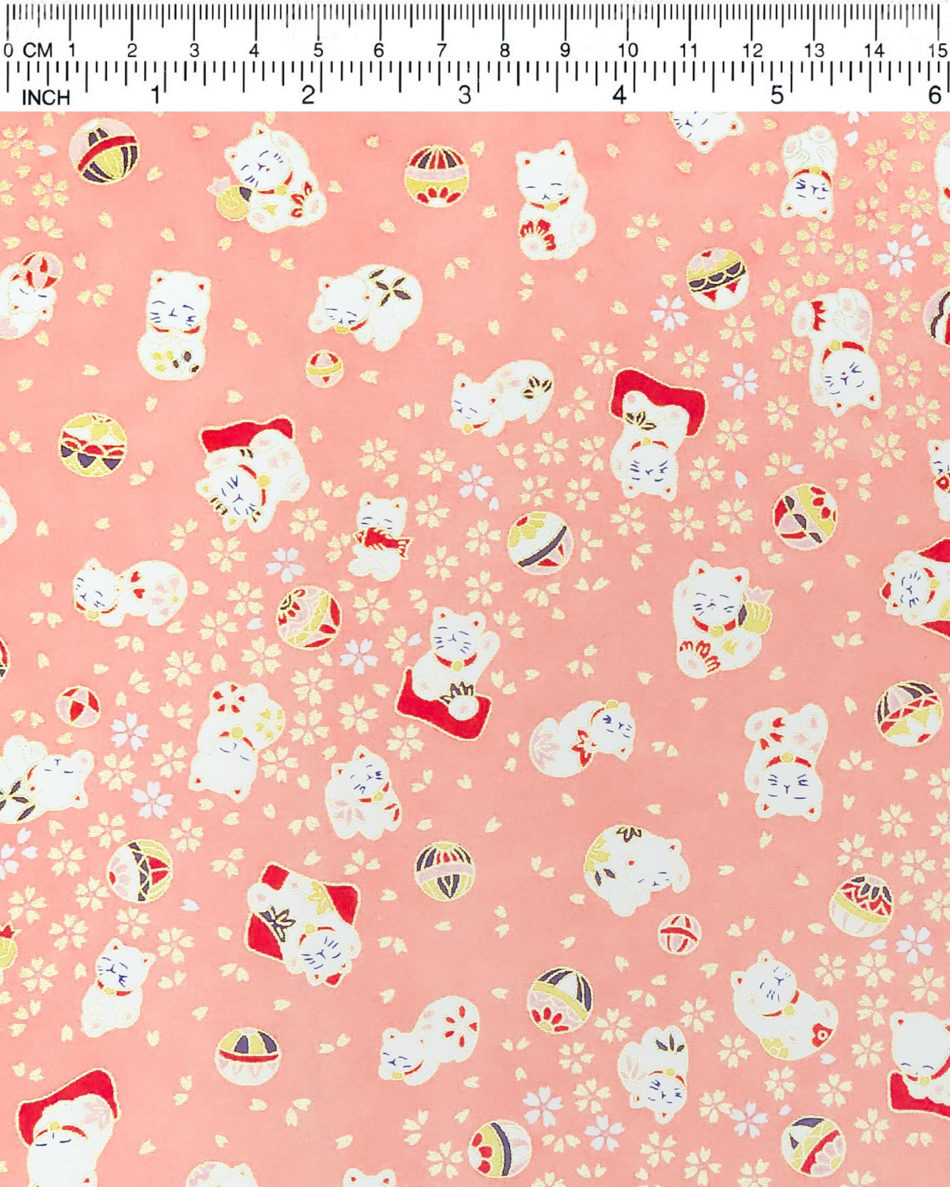 Japanese chiyogami featuring white Maneki Neko lucky cats on a pink background with metallic gold accents.