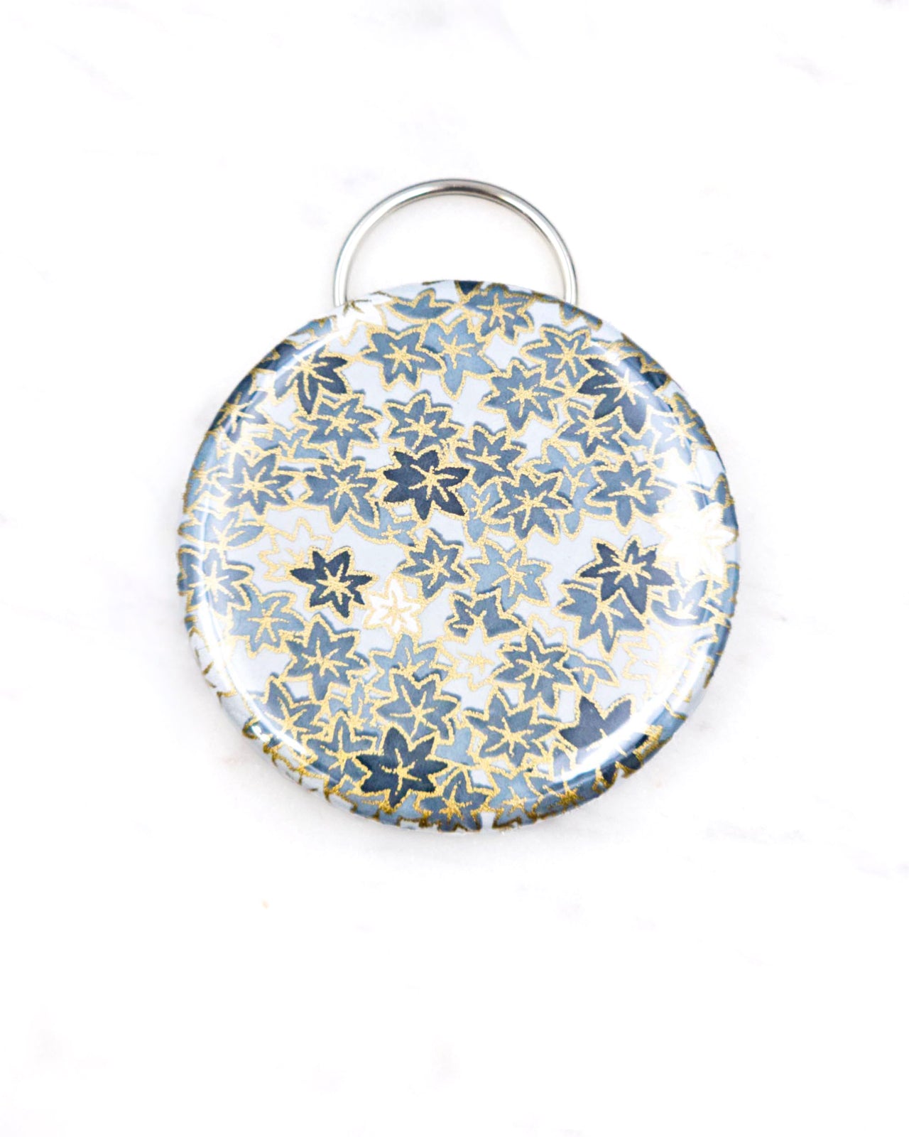 Magnetic bottle opener featuring gray and white maple leaves with metallic gold accents.