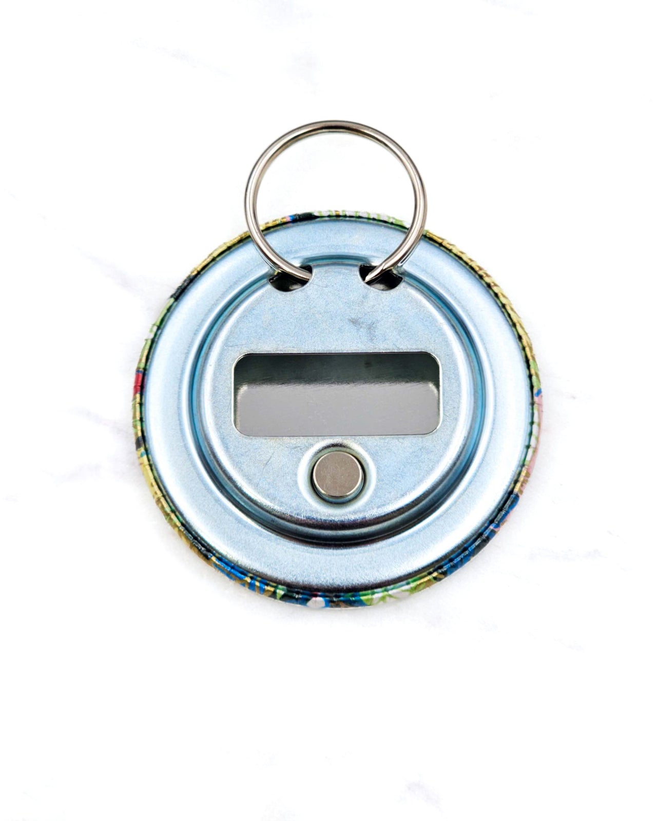 Magnetic bottle opener featuring yellow, blue, and green leaves and persimmons on a green background with metallic gold accents.