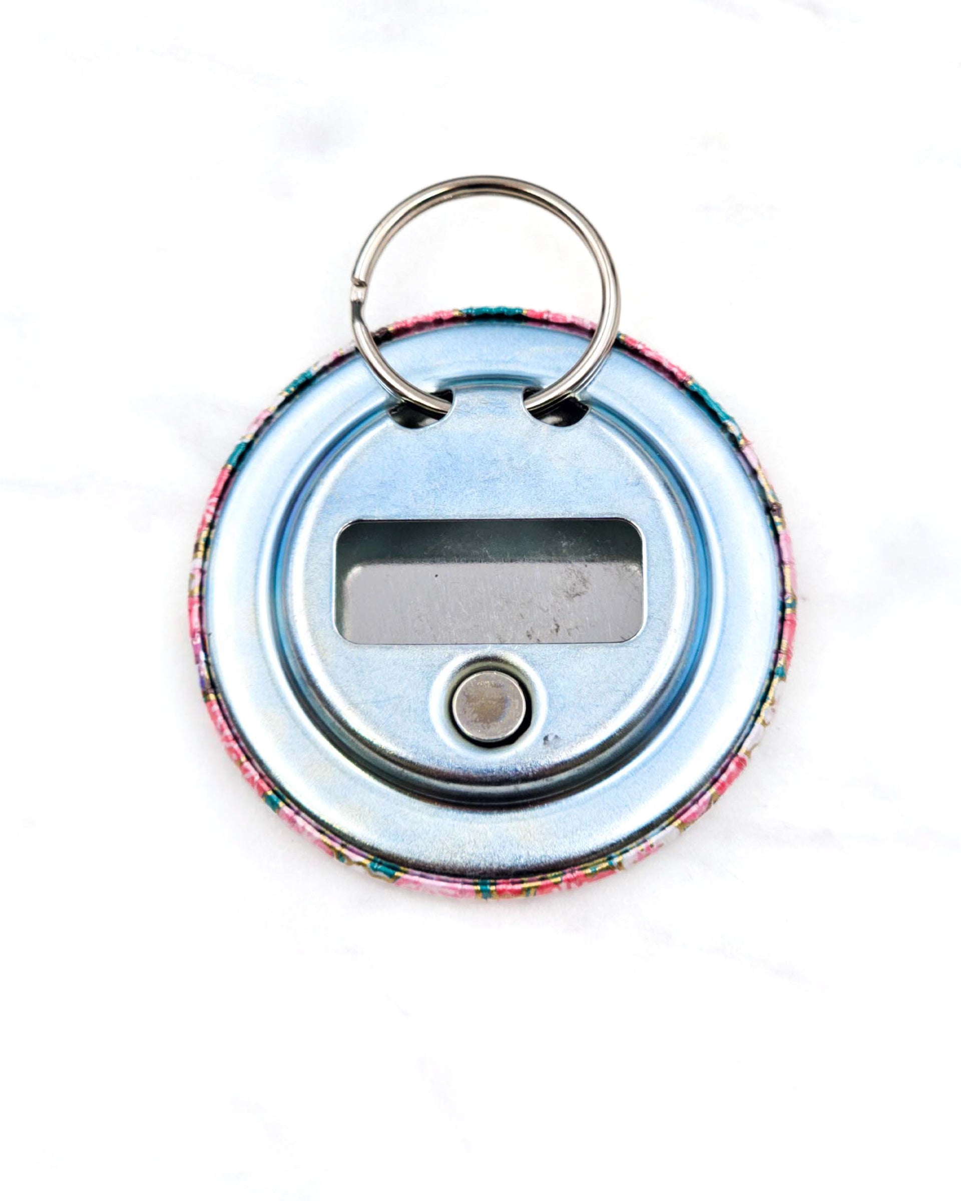 Magnetic bottle opener featuring pink plum blossoms on a teal green background with metallic gold accents.