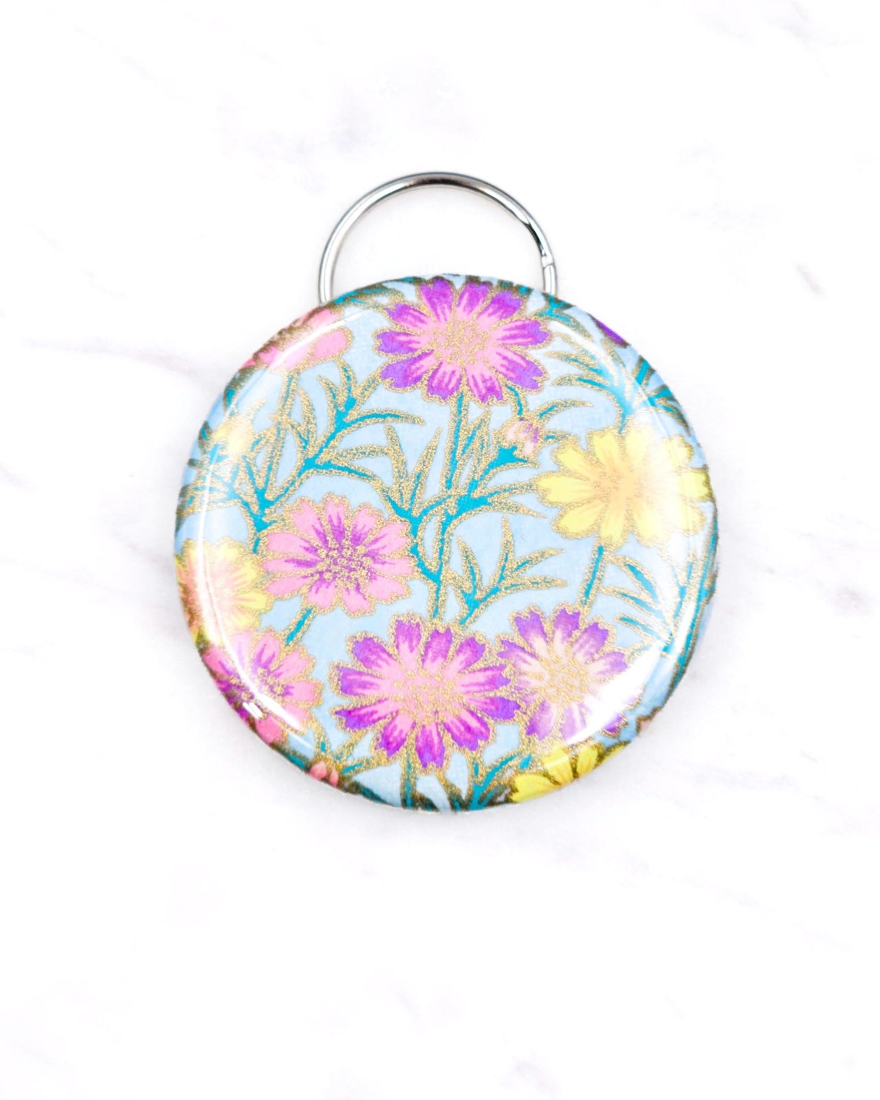 Magnetic bottle opener featuring purple and yellow flower stalks on a light blue background with metallic gold accents.