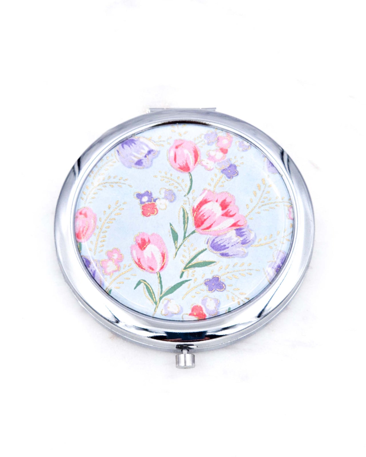 Silver metal compact mirror featuring purple and pink tulips on a light blue background with metallic gold accents.