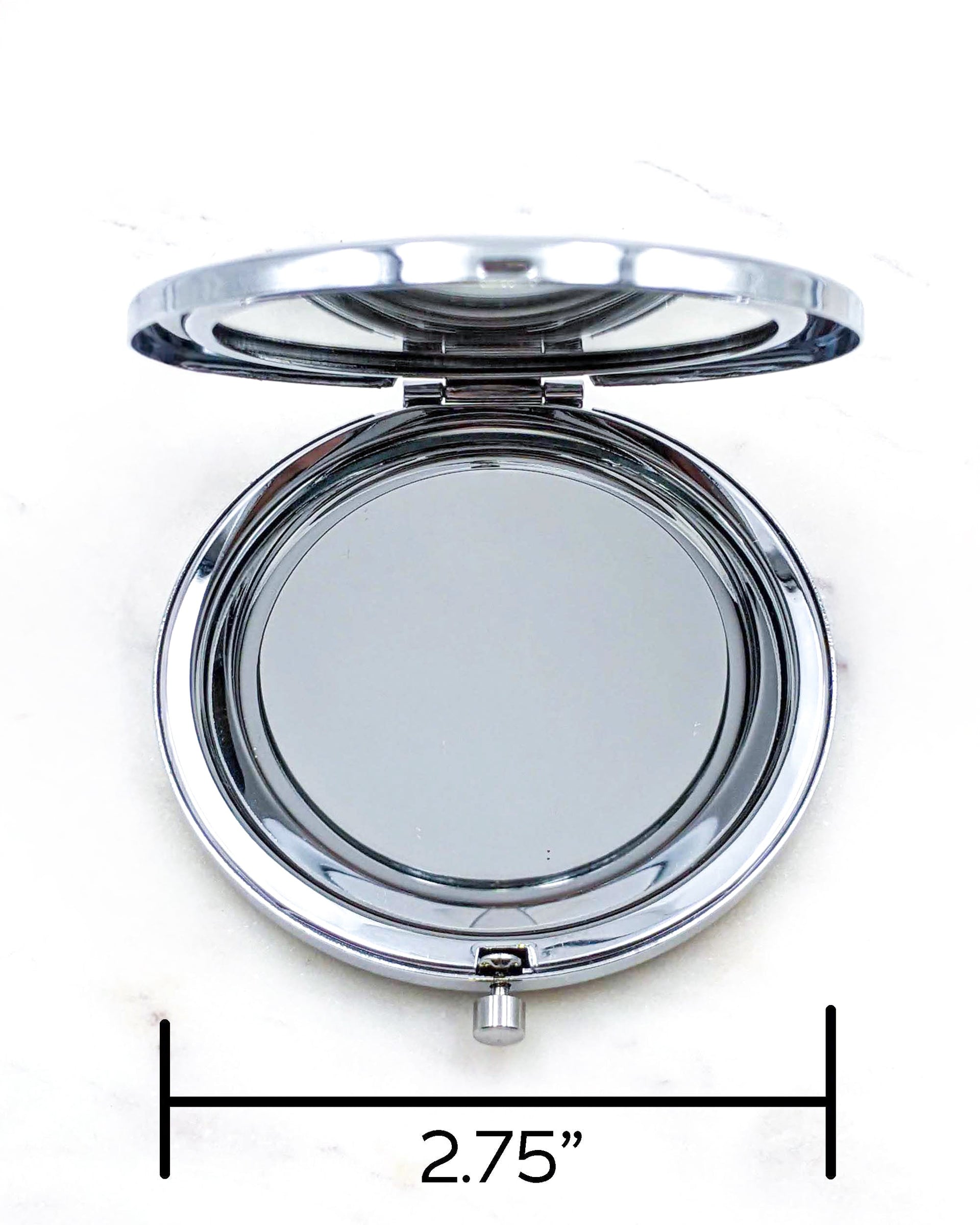 Opened silver compact mirror