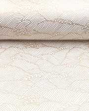 Japanese chiyogami featuring small metallic gold waves on a white background.