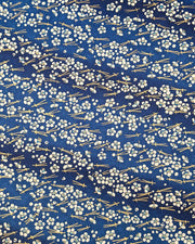 Japanese chiyogami featuring small white plum blossoms & matsuba (pine needles) on a blue background with metallic gold accents.