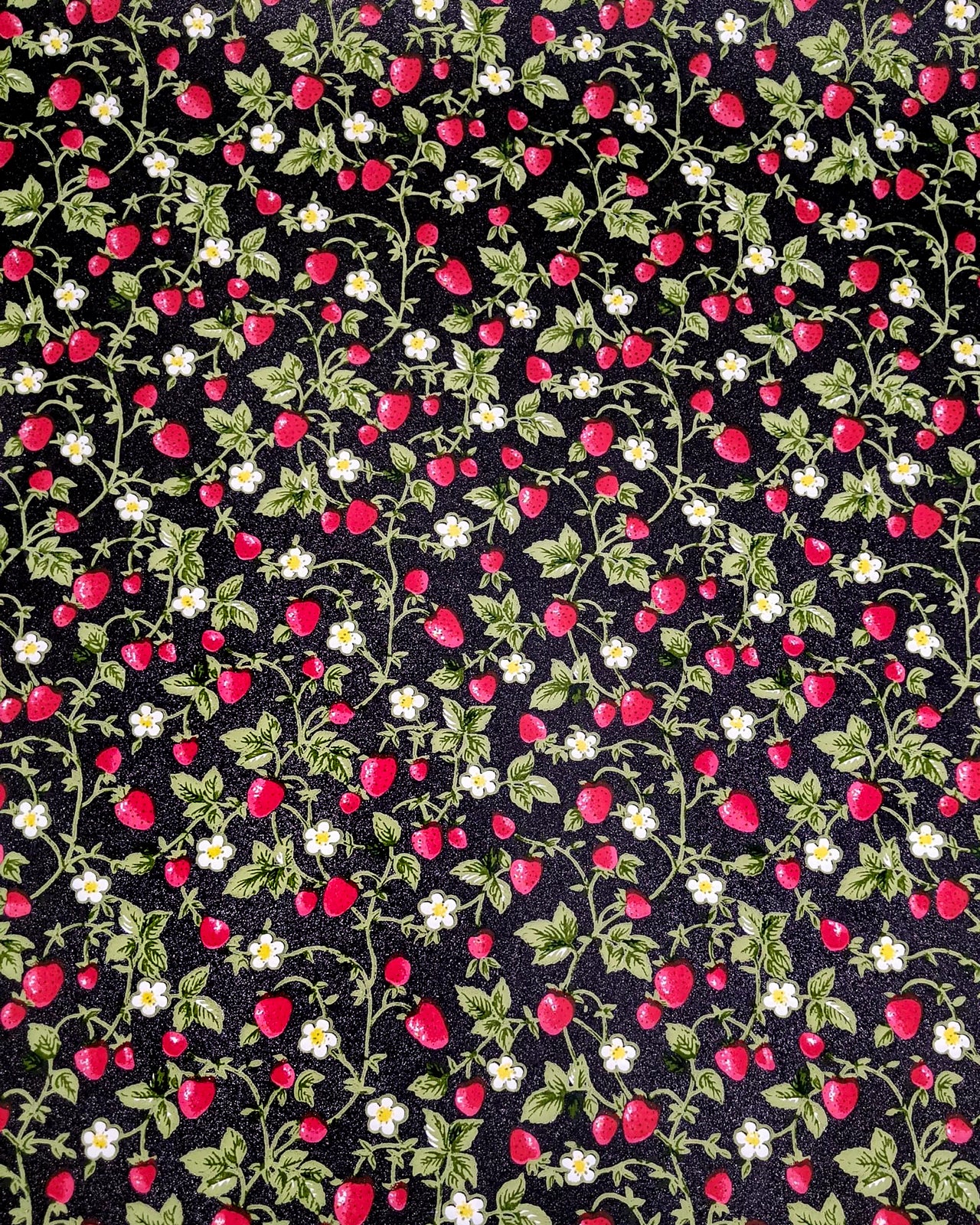 Japanese chiyogami paper featuring red strawberries with green leaves and white flowers on a glittery black background.