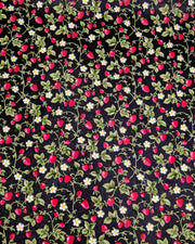 Japanese chiyogami paper featuring red strawberries with green leaves and white flowers on a glittery black background.