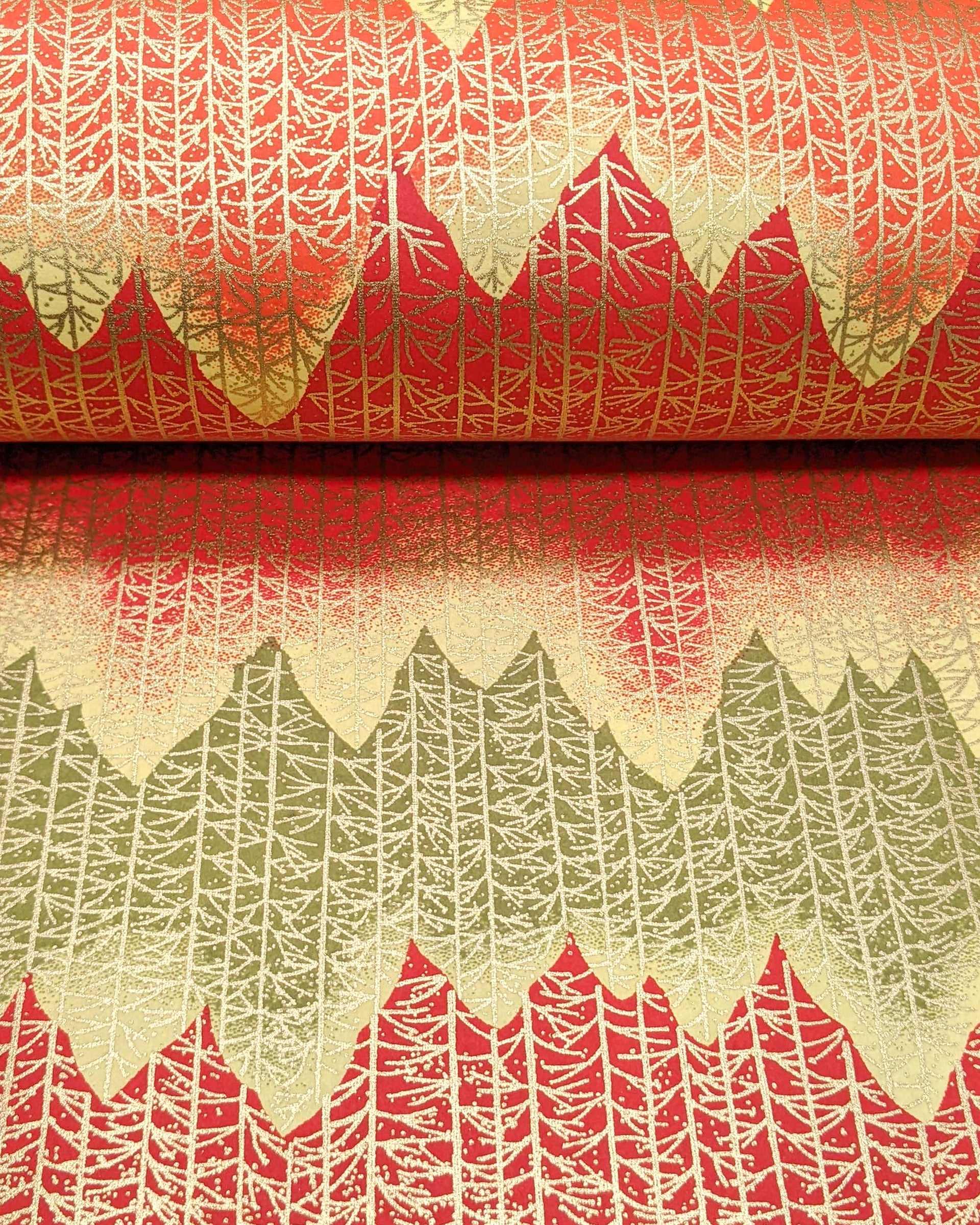 Japanese chiyogami paper featuring a orange, yellow, and green forest with metallic gold trees.