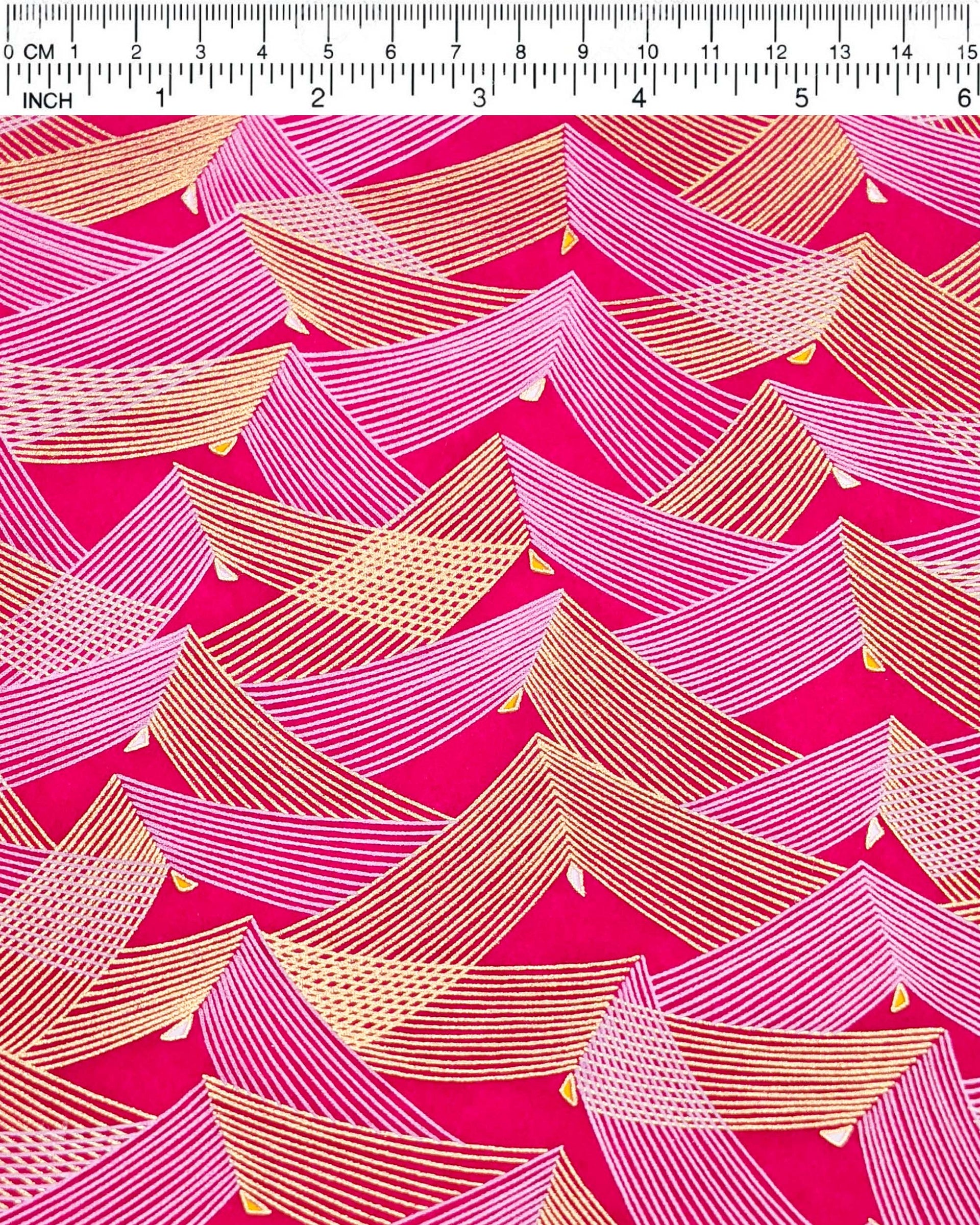 Japanese chiyogami paper featuring metallic gold & white triangles on a magenta pink background.