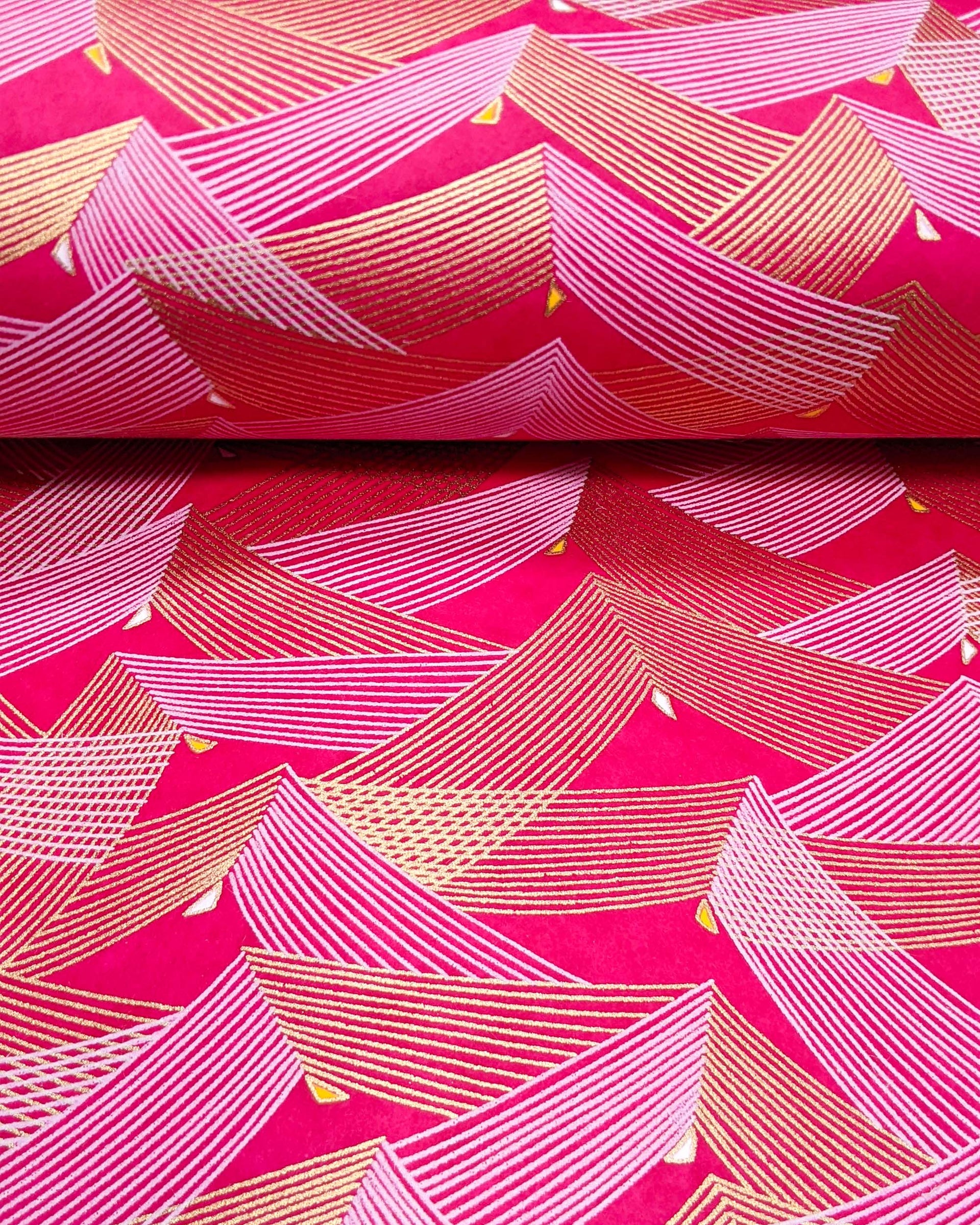 Japanese chiyogami paper featuring metallic gold & white triangles on a magenta pink background.